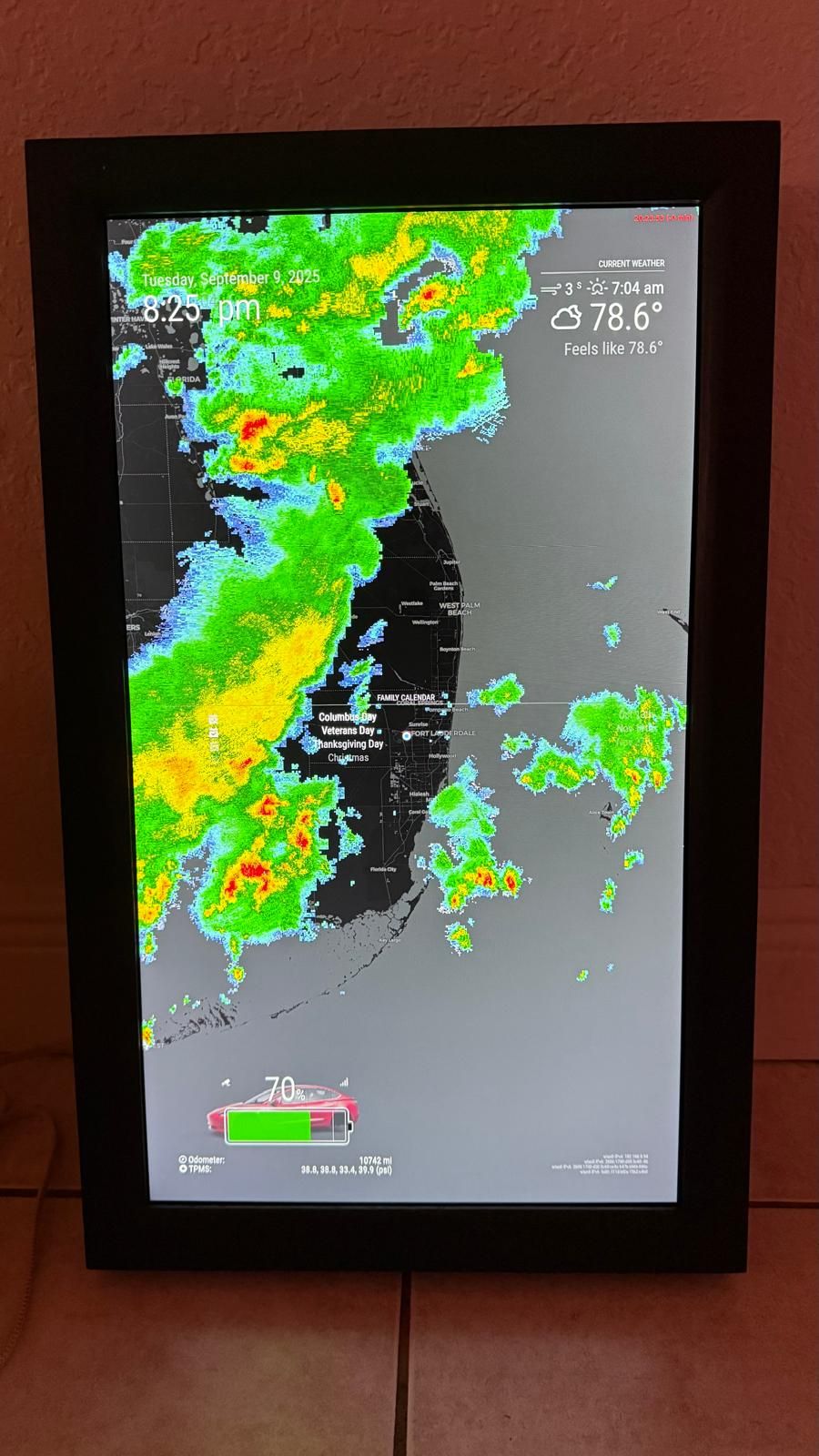 Customer install — portrait display showing live Florida radar